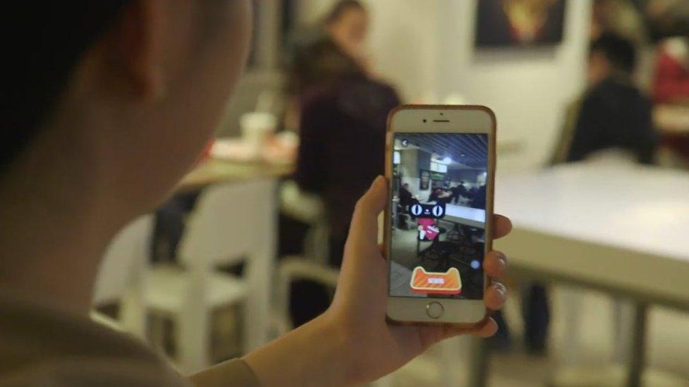 Patron at a KFC outlet in Hangzhou playing with Alibaba's augmented reality game