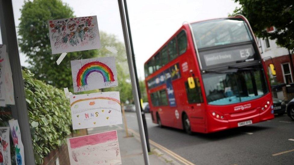 Bus going past pictures stuck on bus stop