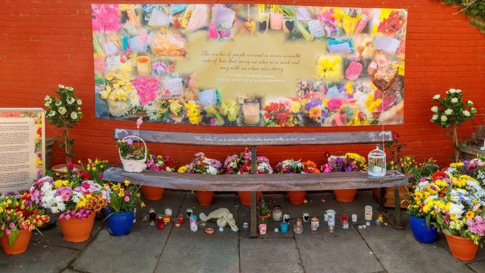 Flowers at the bench where Libby Squire was last seen