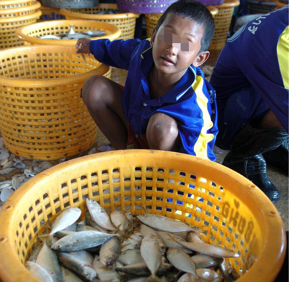 Ting Anan Maigait, a young boy working on a boat at the Mahachai port.