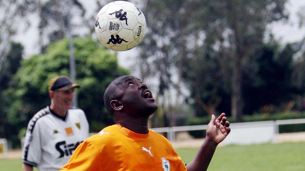 Burundian President Pierre Nkurunziza heads the ball in Abidjan February 2007