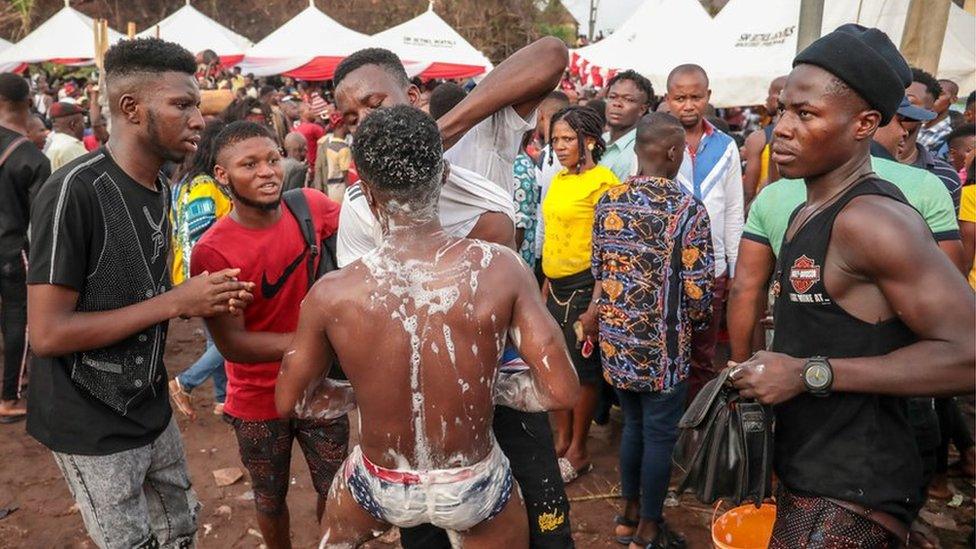 Man being washed as part of rituals in Arondizuogu during the Ikeji Festival in Nigeria