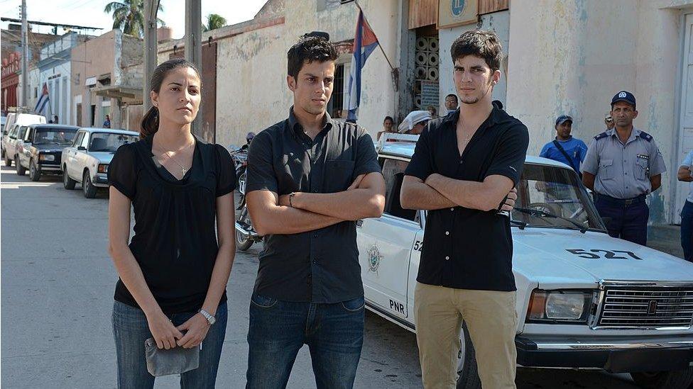 The children of deceased opposition leader Oswaldo Paya stand in front of a police patrol car, on 5 October 2012 in Bayamo, Cuba.