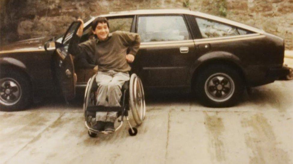 Andrew in his wheelchair as a teenager in the 1980s