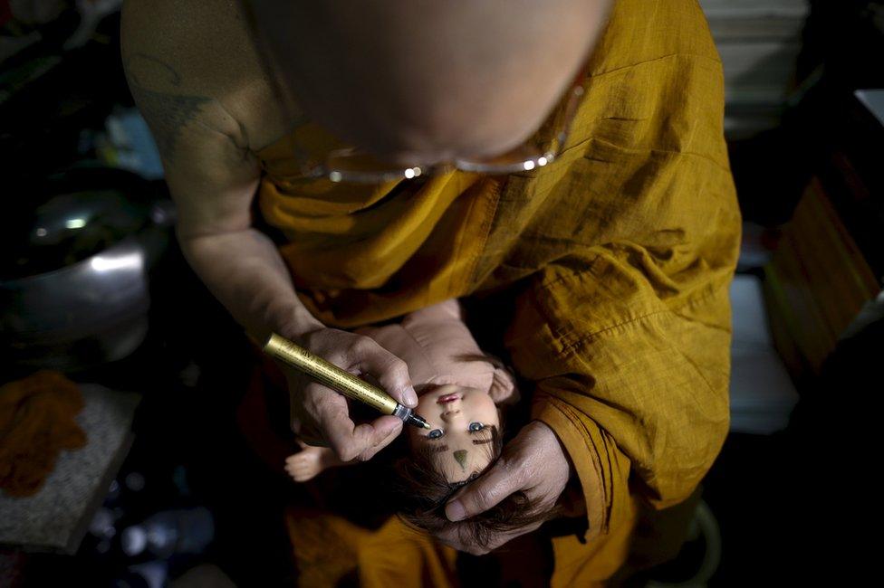 Buddhist monk Phra Winai Thidtapanyo, 64, anoints on a "child angel" doll during a blessing ritual at Wat Bua Khwan temple in Nonthaburi, Thailand, 26 January 2016.