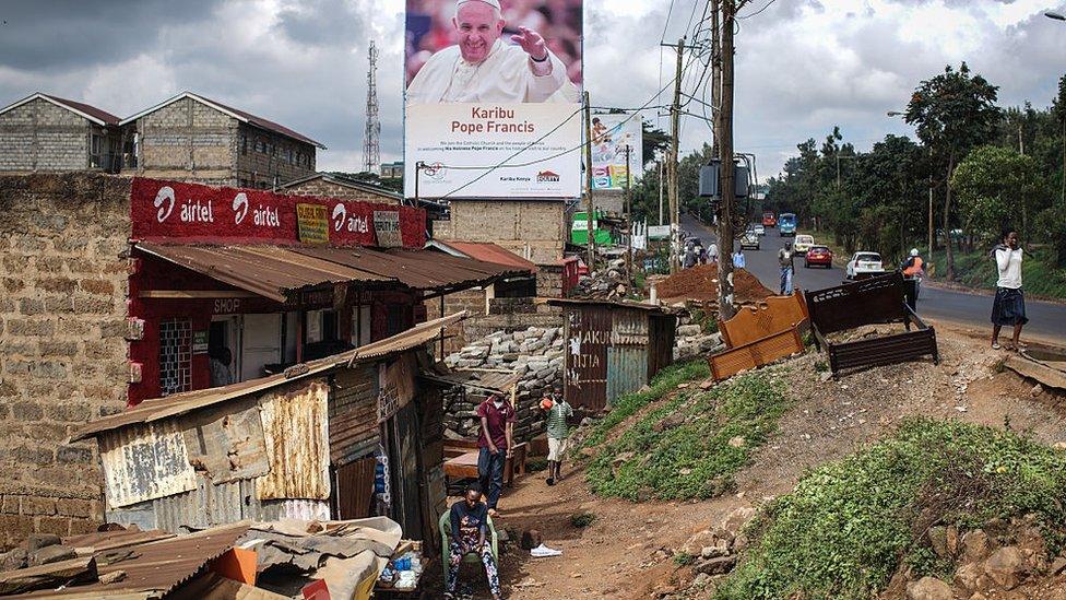 A poster welcoming Pope Francis to Kenya is pictured in the Kangemi slum on November 24, 2015 in Nairobi, Kenya.