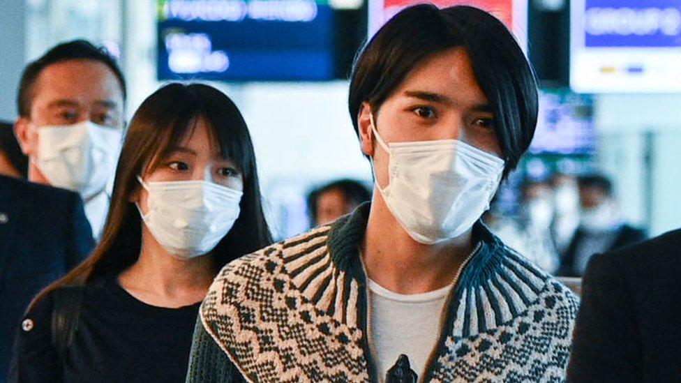 Japans former princess Mako Komuro and Princess Kiko, and her husband Kei Komuro walk to their departure gate for their flight to New York.