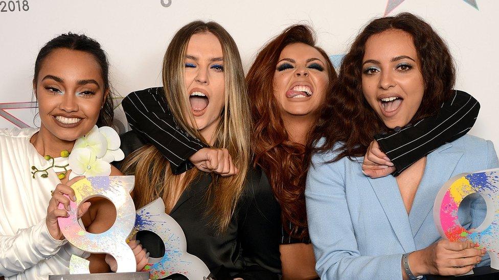 Little Mix pulling silly faces at a ceremony with awards