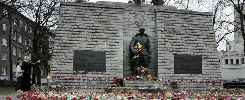 Flowers and candles decorate the area around the Bronze Soldier statue, a Soviet World War II memorial, 26 April 2007 in Tallinn