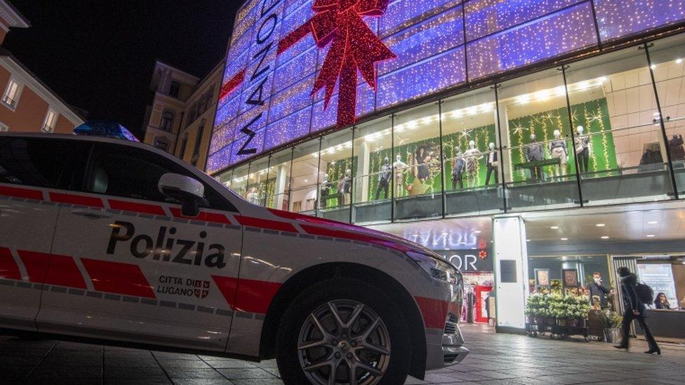 A police car is parked outside the department store where the attack took place