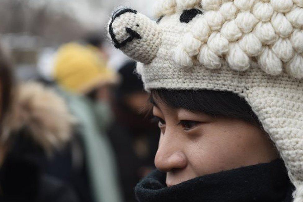 A Chinese lesbian, who goes by the pseudonym Qiu Bai, speaks to the media before entering the Beijing No.1 Intermediate People's Court in Beijing on November 24, 2015.