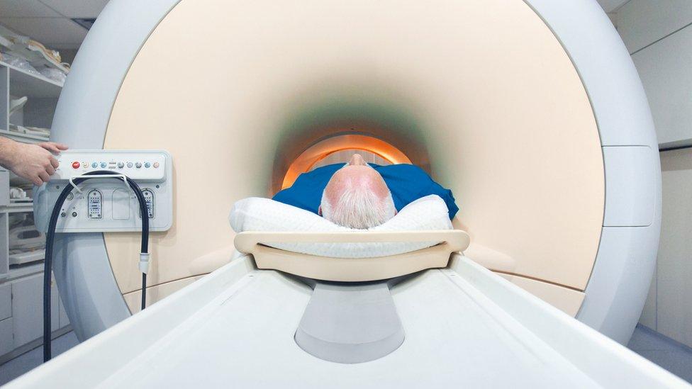 Man going into an MRI scanner