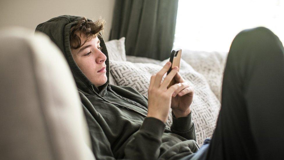 Teenage boy on smartphone