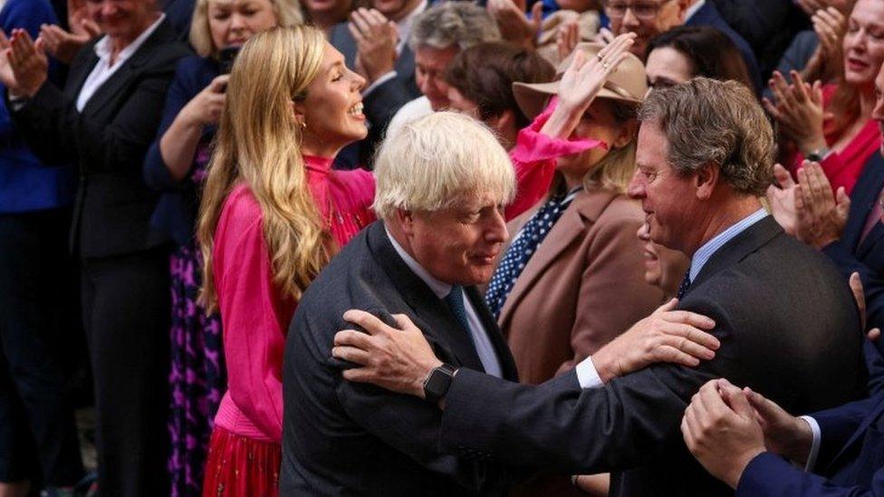 Outgoing British Prime Minister Boris Johnson, with his wife Carrie Johnson, greet people outside No 10 Downing Street