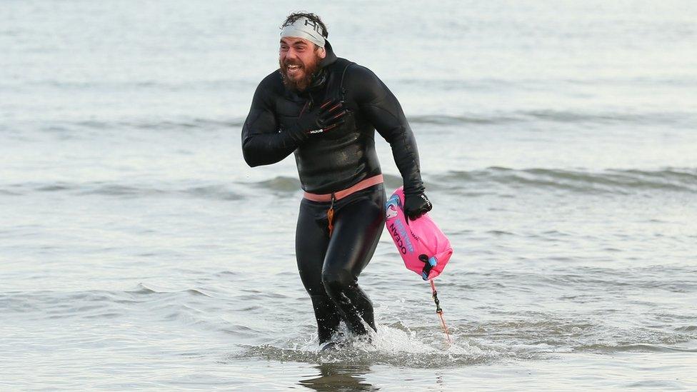 Ross Edgley walking out of the sea