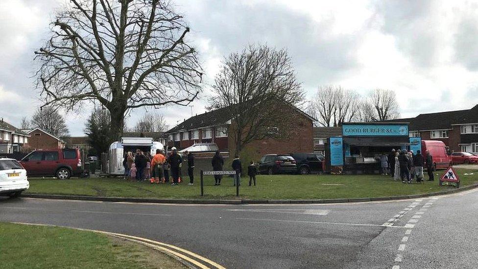 Residents queuing for hot food