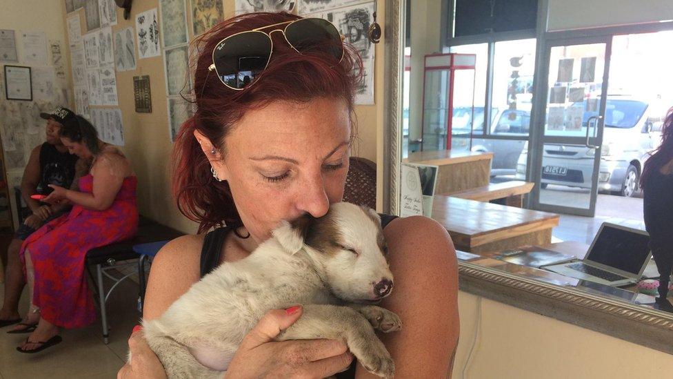 Angela Glover with a rescued puppy