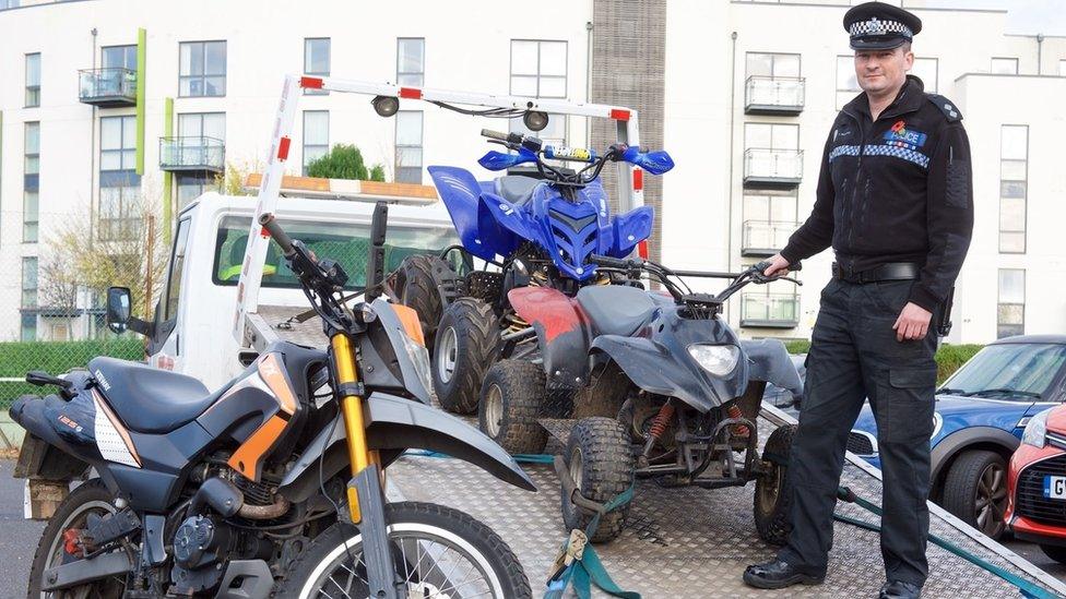 Police officer with off road quad and motor bikes