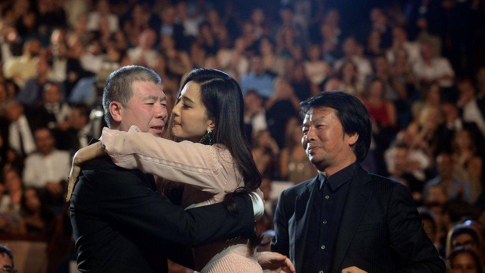 Director Feng Xiaogang, Concha de Oro (Golden Shell) award winner for best film, embraces Concha de Plata (Silver Shell) for best actress award winner Fan Bing Bing, both for the feature film I Am Not Madame Bovary, during the awards ceremony at the San Sebastian Film Festival, September 24, 2016