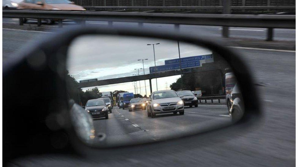 Motorist looks in mirror