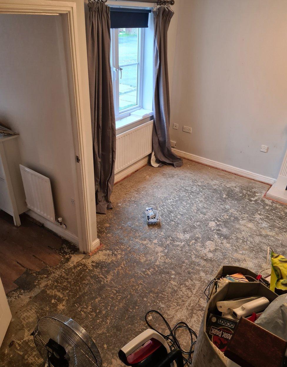 The flood-damaged property with carpets taken up