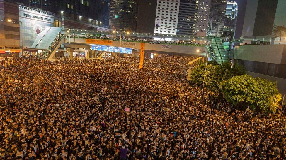 Pro-democracy protesters (protestors, demonstrators) outside the Hong Kong government headquarters, on the second day of the mass civil disobedience campaign Occupy Hong Kong, Admiralty, Hong Kong, China, 29 September 2014.