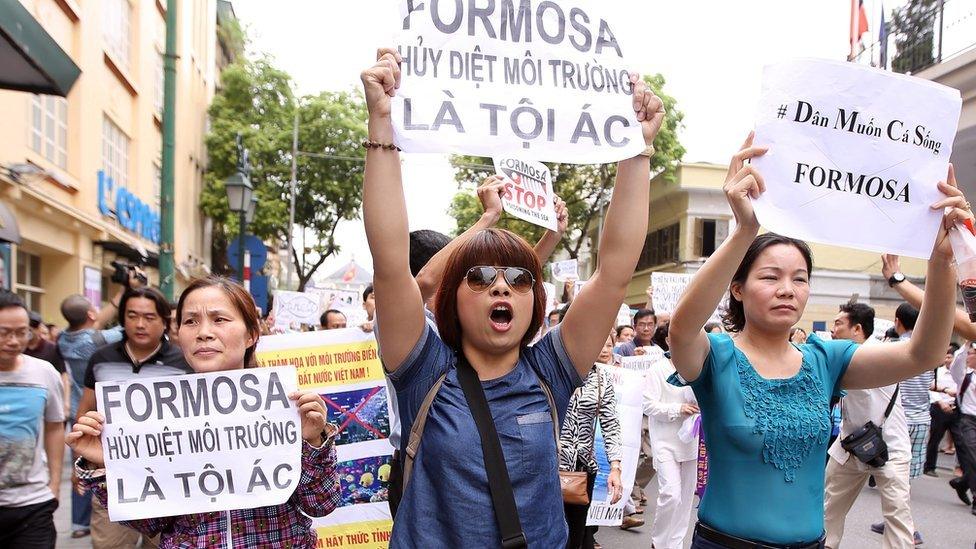 Vietnamese protesters hold banners reading "Formosa destroys the environment, which is a crime" during a rally in Hanoi on 1 May, 2016