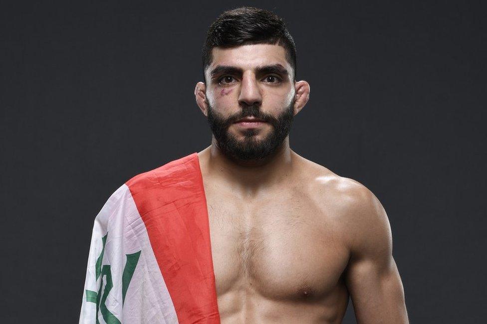 Amir Albazi with an Iraqi flag on his shoulder