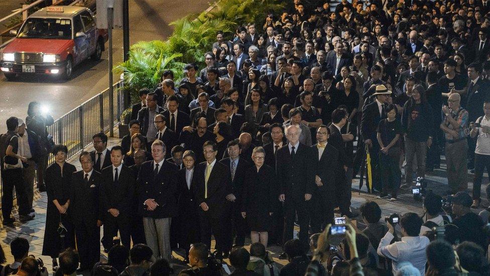 Lawyers and law students take part in a silent march in protest at a ruling by China which effectively bars two pro-independence legislators from taking office in Hong Kong on November 8, 2016