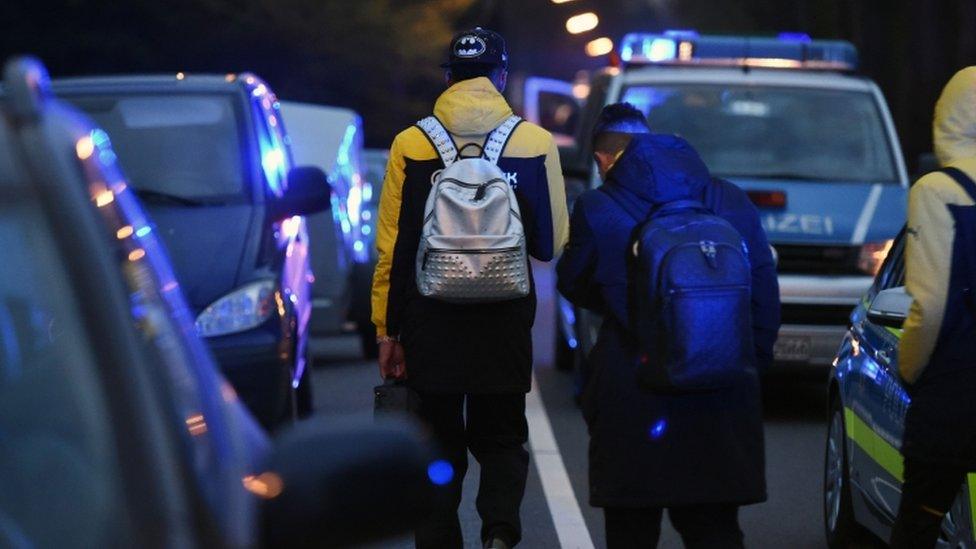 Star striker Pierre-Emerick Aubameyang leaves the bus with teammates after the blasts