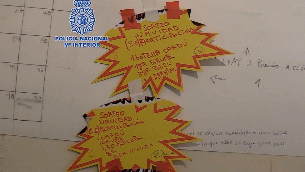 Two yellow stickers announce the raffles for two narco-hampers in Murcia.