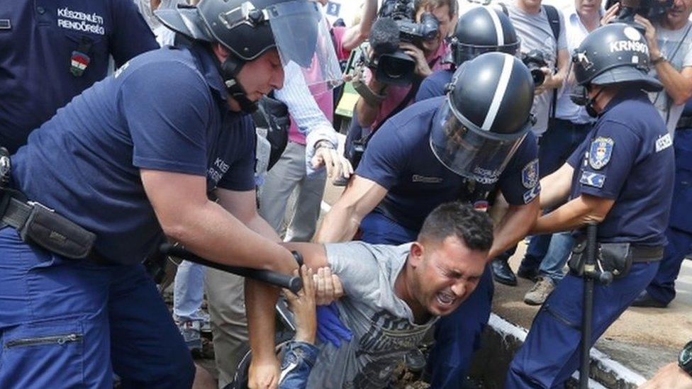 Hungarian police detain migrants at the railway station in the town of Bicske, Hungary, on 3 September, 2015.