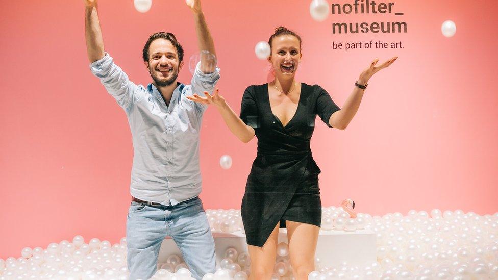 Two people in a ball pit room