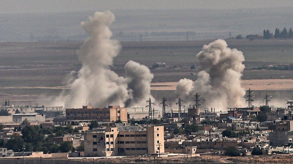 Smoke rises from the Syrian town of Ras al-Ain, in a picture taken from the Turkish side of the border in Ceylanpinar on October 11, 2019