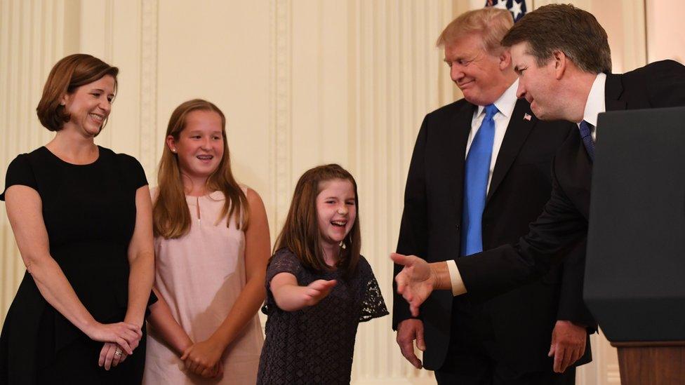 US President Donald Trump (2ndR) smiles as US Judge Brett Kavanaugh shakes hands with his daughter