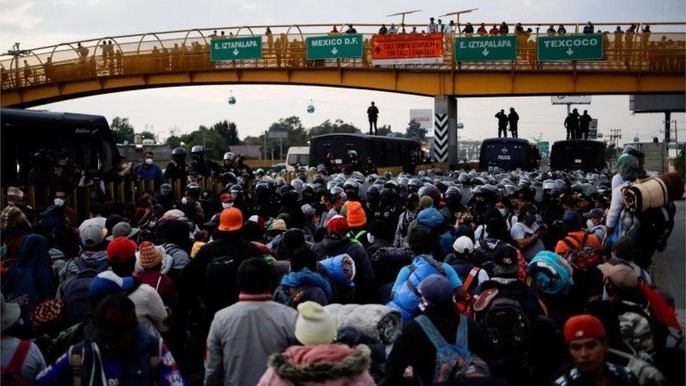 Police prevent members of the migrant caravan from passing on the Mexico-Puebla highway, in Los Reyes La Paz, Mexico, December 12, 2021.