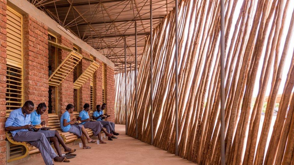 Students in Lycée Schorge secondary school. Beams of light are entering the building.