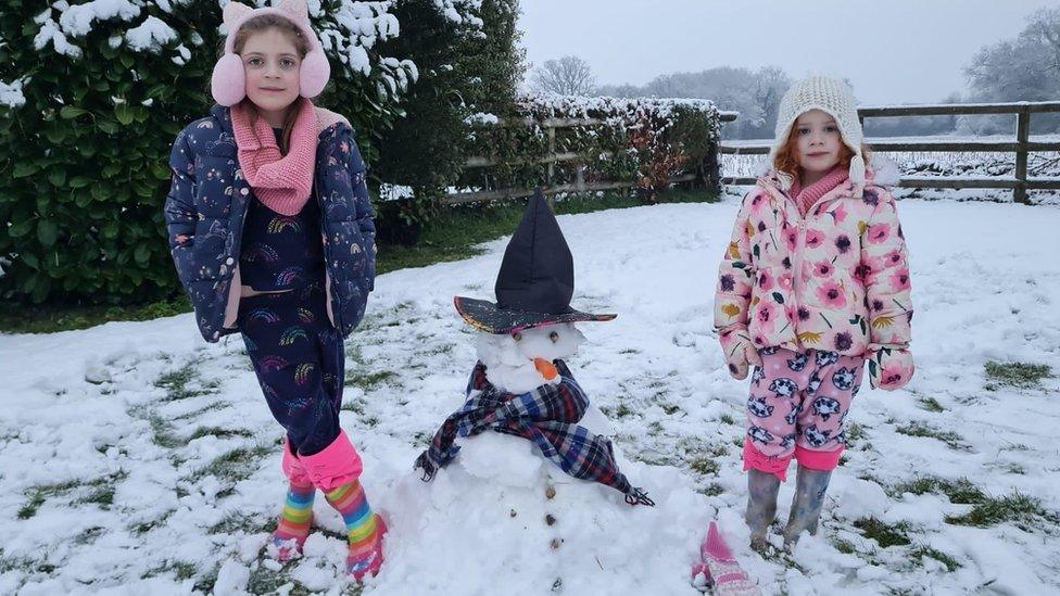 Emilee & Sophie in Shinfield Berkshire making a snowman before school