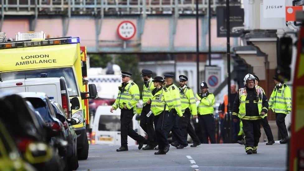 Police and fire services gather at the scene of an incident on the District line in London