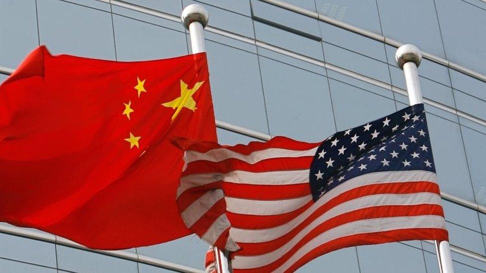 Flags of China (left) and the US. File photo