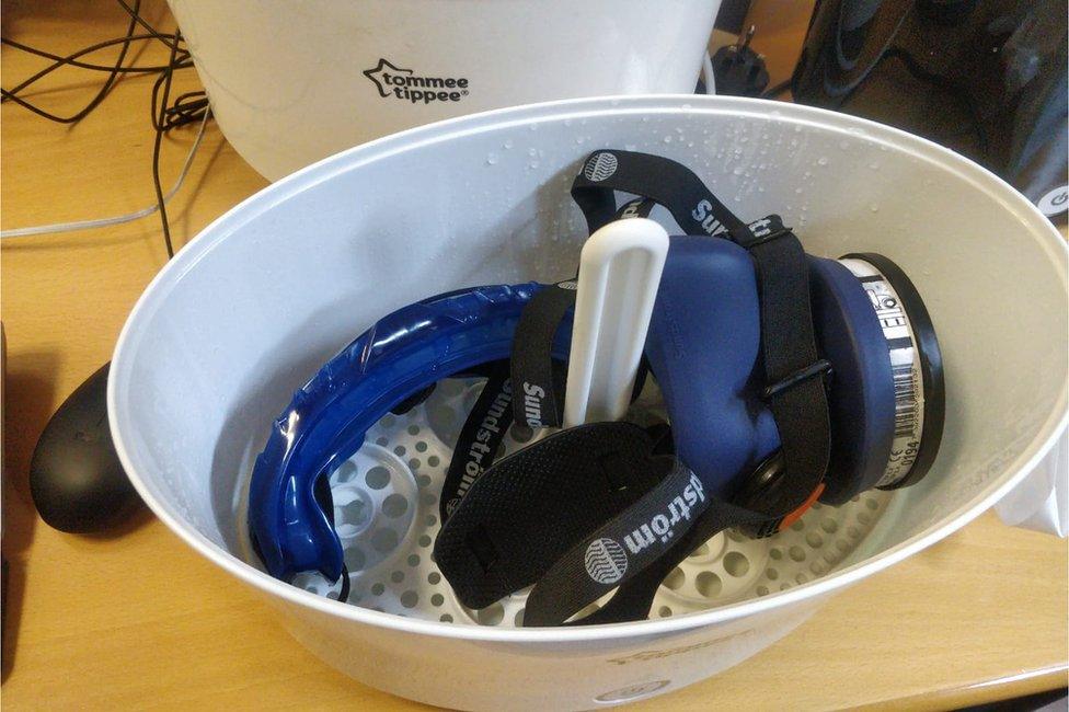 A mask in a bowl for sterilisation