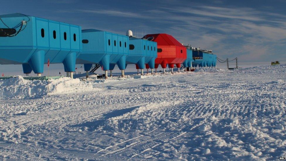 Halley research station in the foreground. The sky is bright blue