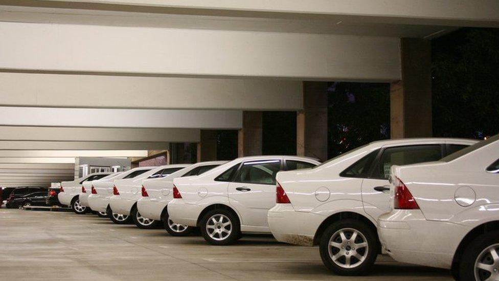 White cars in a car park