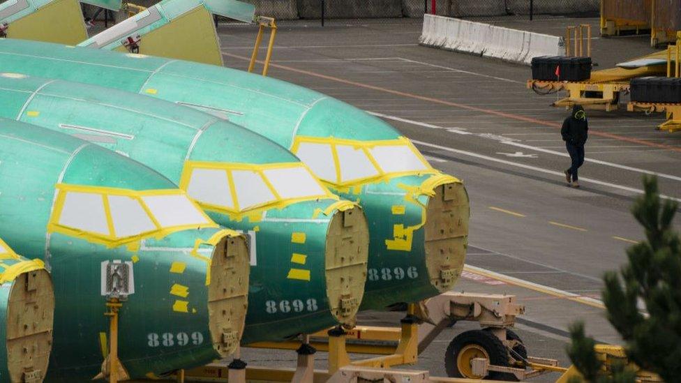 A worker walks near Boeing 737 fuselages outside the Boeing Co. manufacturing facility in Renton, Washington, US, on Monday, Feb. 5, 2024.