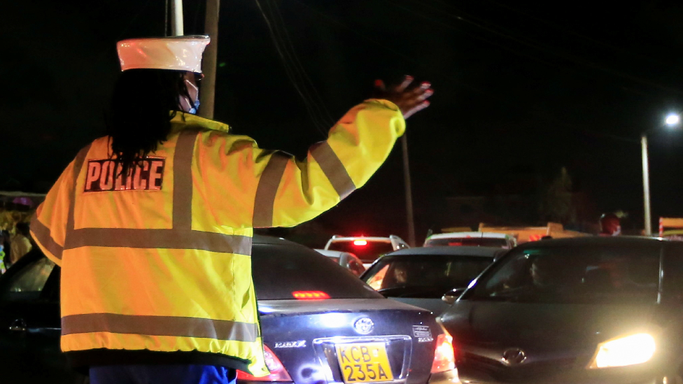 An officer at a curfew roadblock in Nairobi, Kenya