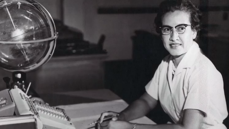 Katherine Johnson sits with a globe