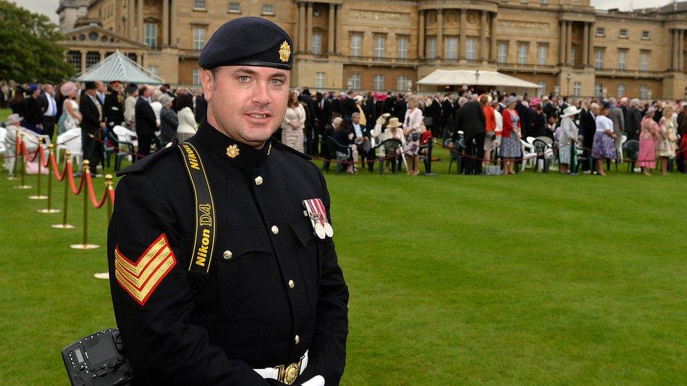 Steve Blake in ceremonial uniform and carrying a camera