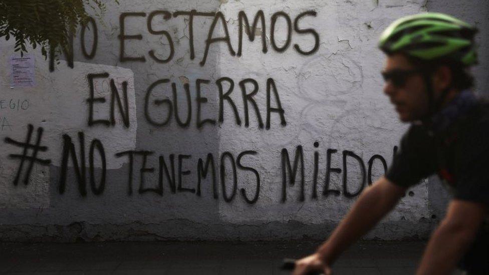 Graffiti on a wall in Santiago proclaims: "We're not at war #we're not afraid"