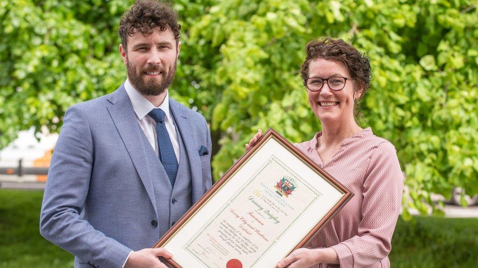 Danny Quigley and mum Denise holding certificate of freedom of Derry