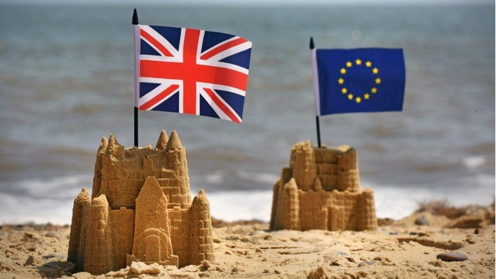 Sandcastles with Union Jack and EU flags